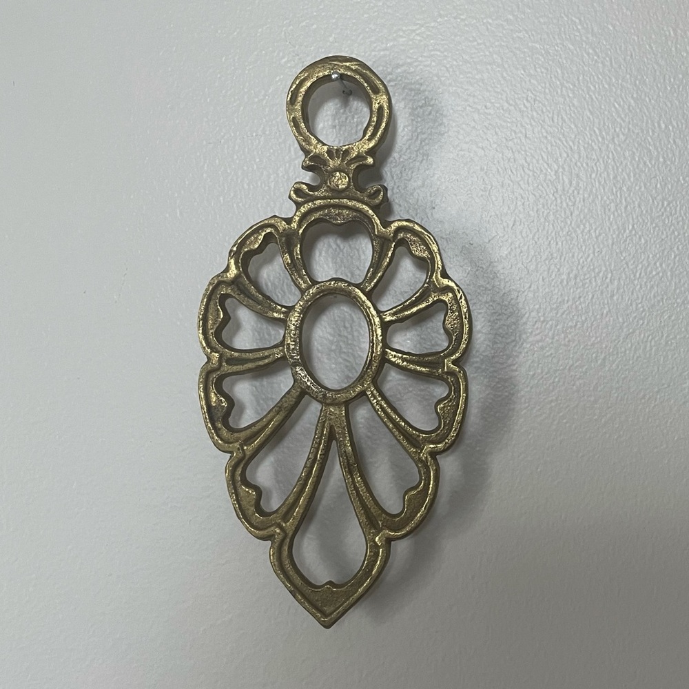 gold-tone metal trivet